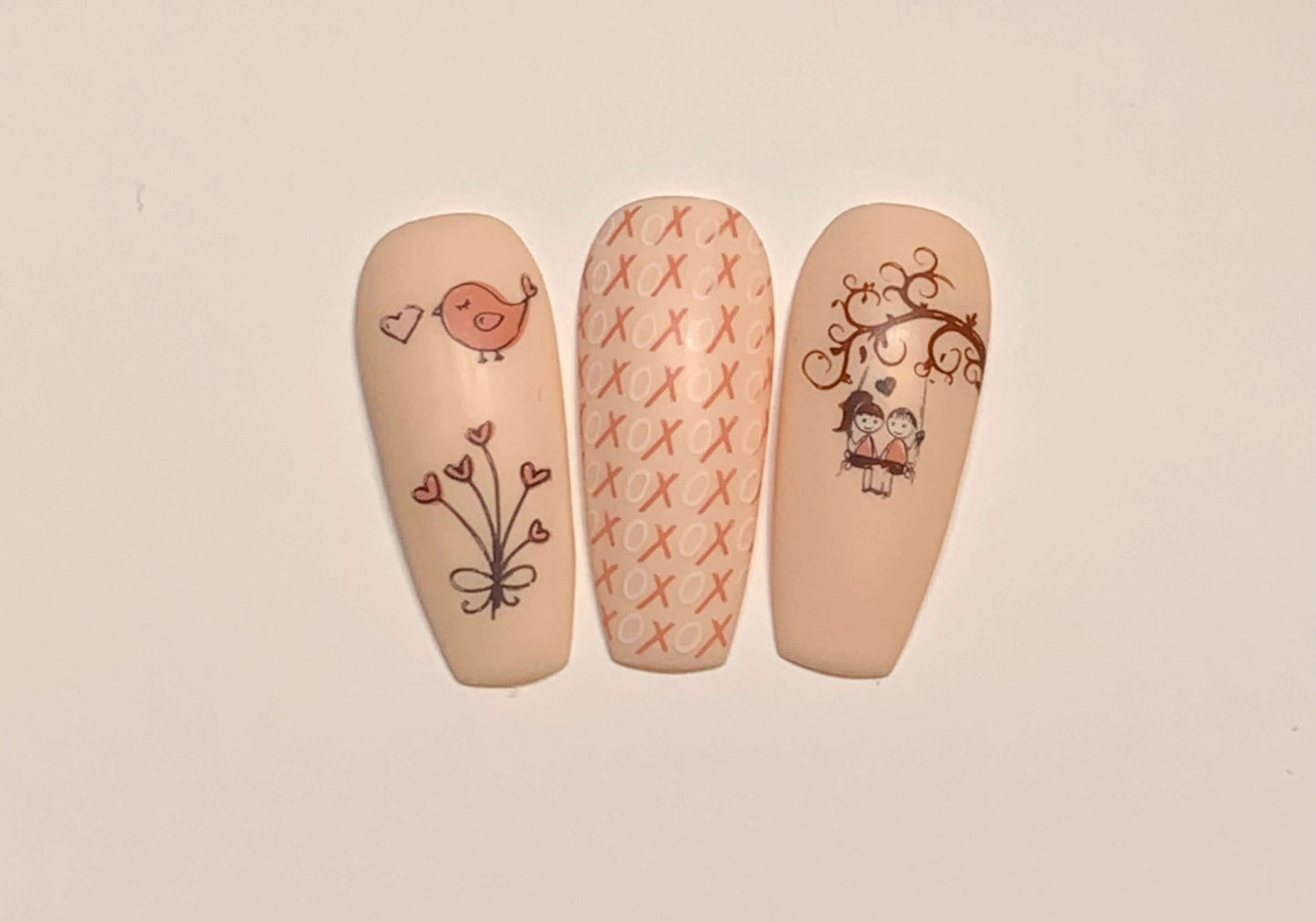 set-of-three-nail-tips-with-layered-nail-art-designs-of-cartoon-couple-love-bird-and-heart-flowers