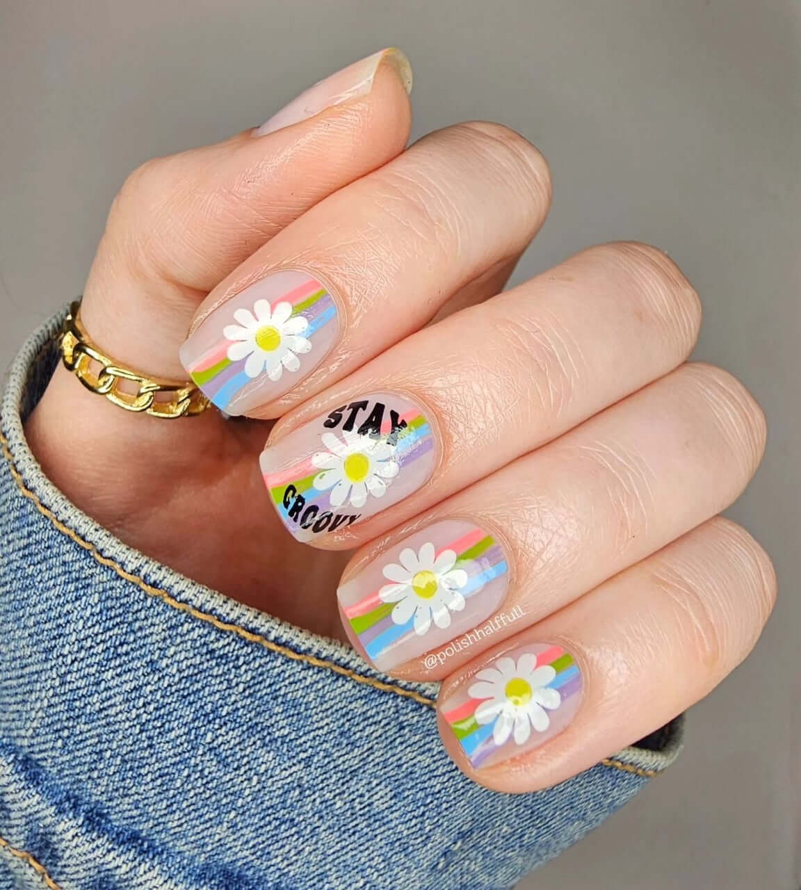 stunning-manicure-with-retro-nail-art-designs-of-stripes-and-daisies-with-the-words-stay-groovy