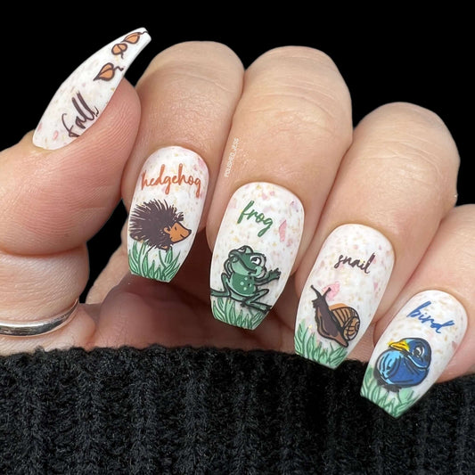 stunning-manicure-with-nail-art-designs-of-a-hedgehog-frog-snail-and-bird