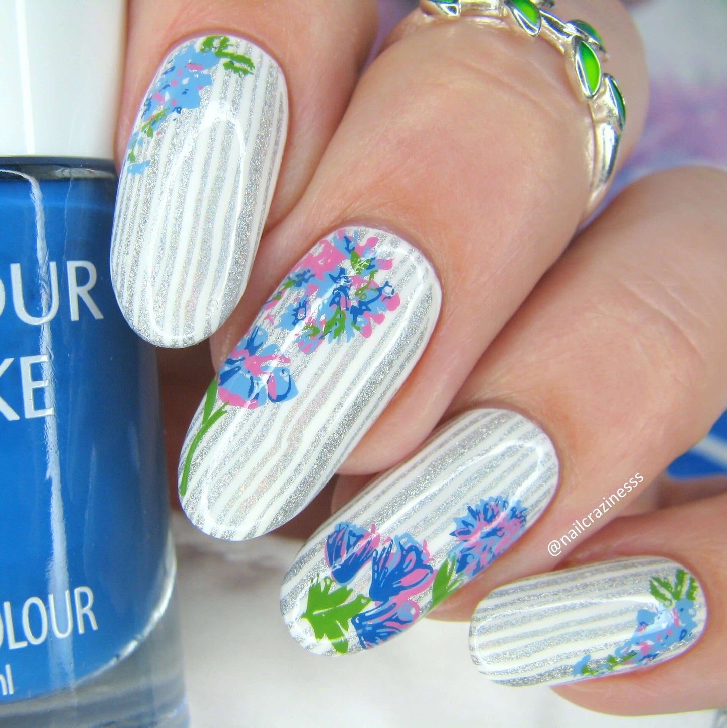 delicate-manicure-with-layered-nail-art-designs-of-full-coverage-stripes-and-floral-designs