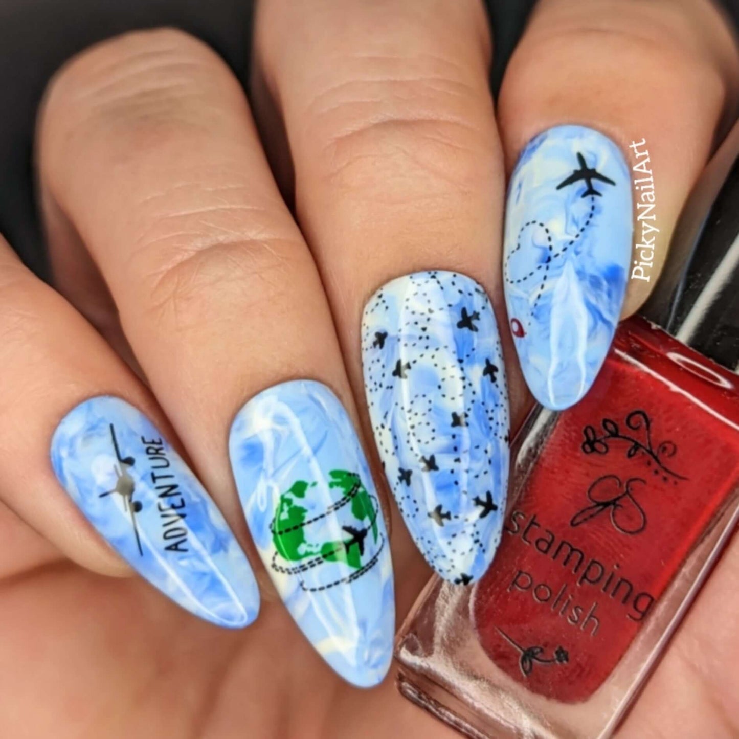 beautfiul-travel-themed-manicure-showing-nail-art-designs-of-planes-and-the-words-adventure