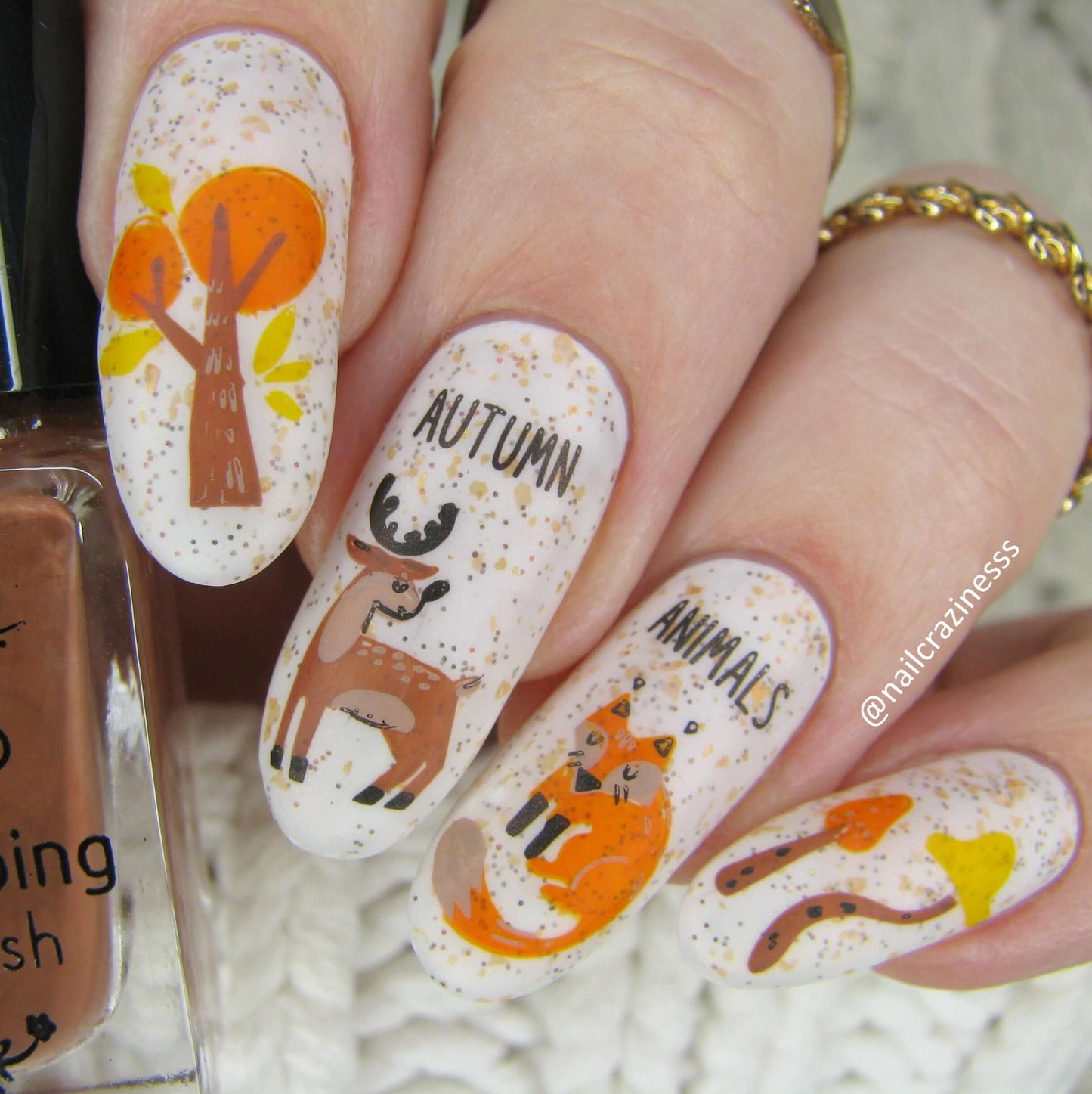 cute-manicure-showing-nail-art-of-a-deer-a-fox-trees-and-the-words-autmn-animals