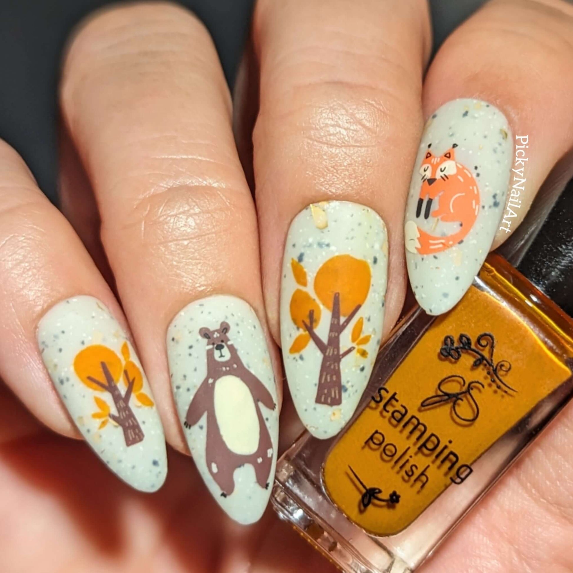 stunning-manicure-showing-nail-art-designs-of-a-bear-a-fox-and-some-fall-trees