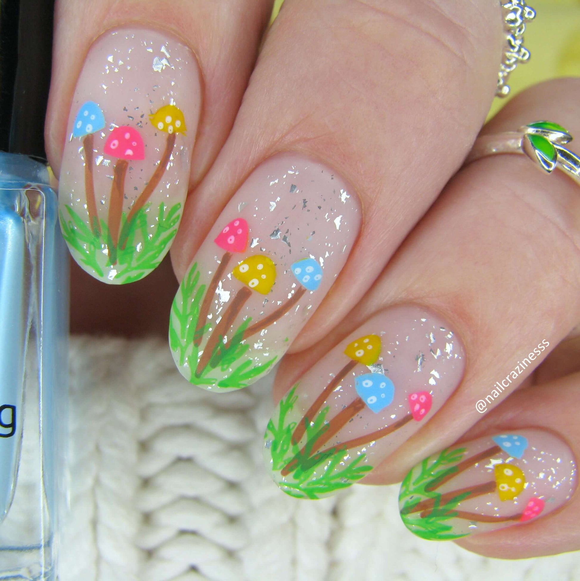 Glittery-manicure-with-nail-art-designs-of-mushrooms-in-grass