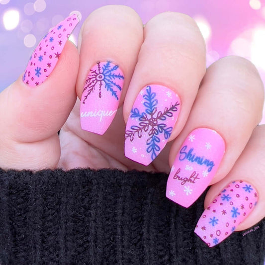 bright-manicure-showing-nail-art-designs-of-snowflakes-with-the-words-shinning-bright-and-unique