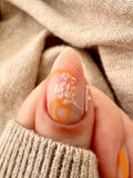 Single-manicured-nail-showing-nail-art-designs-of-modern-boho-shapes-and-leaves