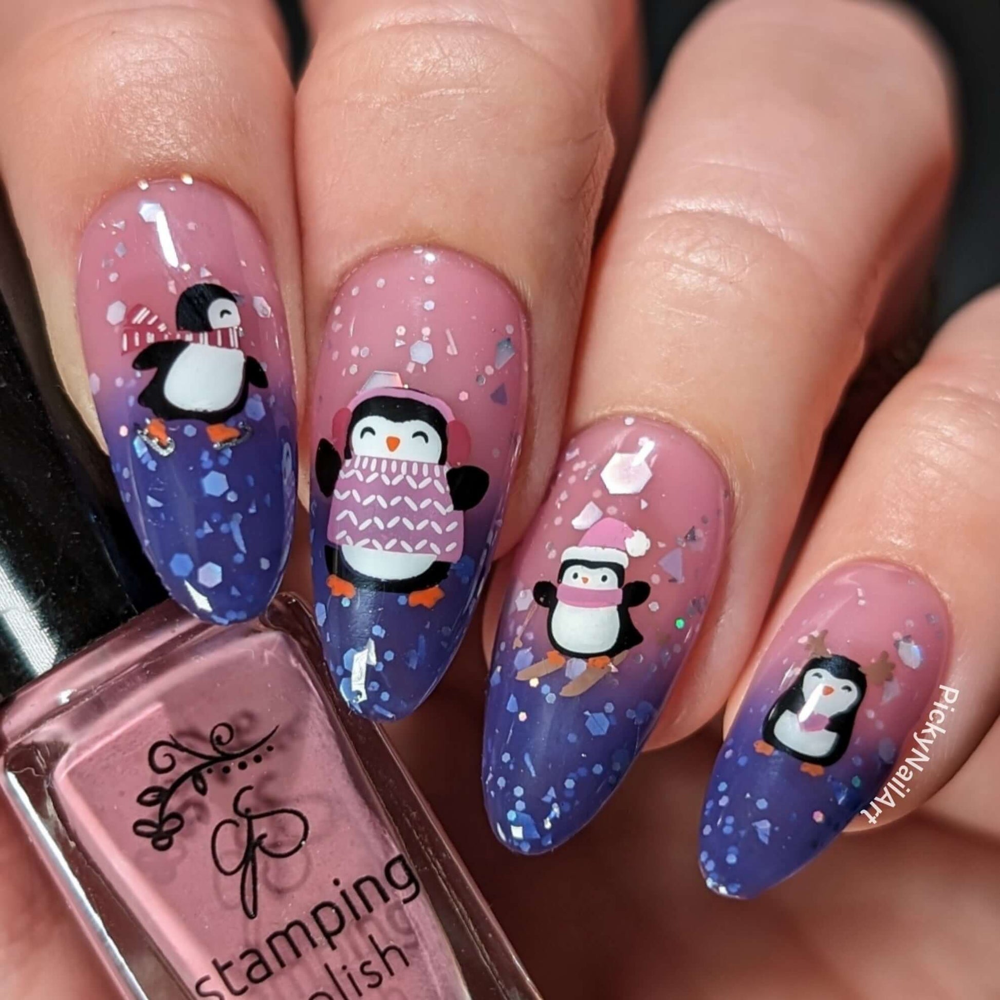 Glittery-manicure-showing-nail-art-designs-of-penguins-with-hats-and-scarves-on