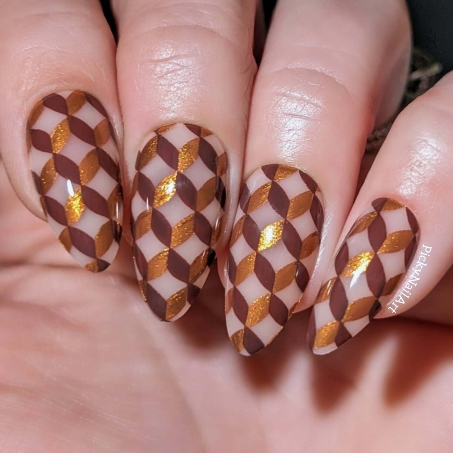 Manicure-showing-full-coverage-geometric-pattern-nail-art-designs-in-brown-and-gold