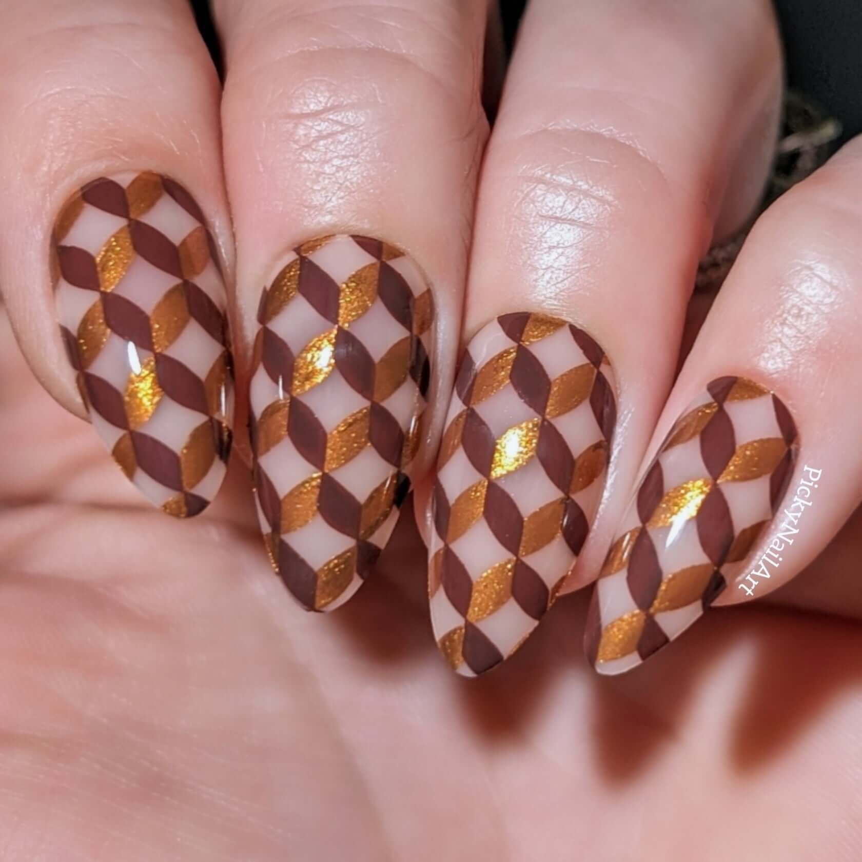 Manicure-showing-full-coverage-geometric-pattern-nail-art-designs-in-brown-and-gold