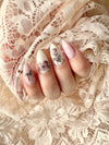 Soft-vintage-style-manicure-showing-nail-art-designs-of-roses-and-a-dragon-fly-on-a-lace-background