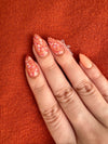 Burnt-orange-manicure-with-full-coverage-nail-art-designs-in-a-floral-pattern