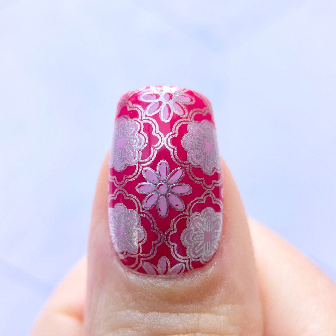 Single-nail-showing-bright-pink-manicure-with-silver-nail-art-designs-of-full-coverage-baroque-floral-pattern
