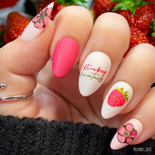 Bright-red-and-white-manicure-showing-nail-art-designs-of-a-strawberry-with-words-strawberry-sweetness