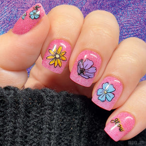 beautiful-manicure-showing-nail-art-designs-of-colorful-flowers-anemone-daisy-and-the-word-grow