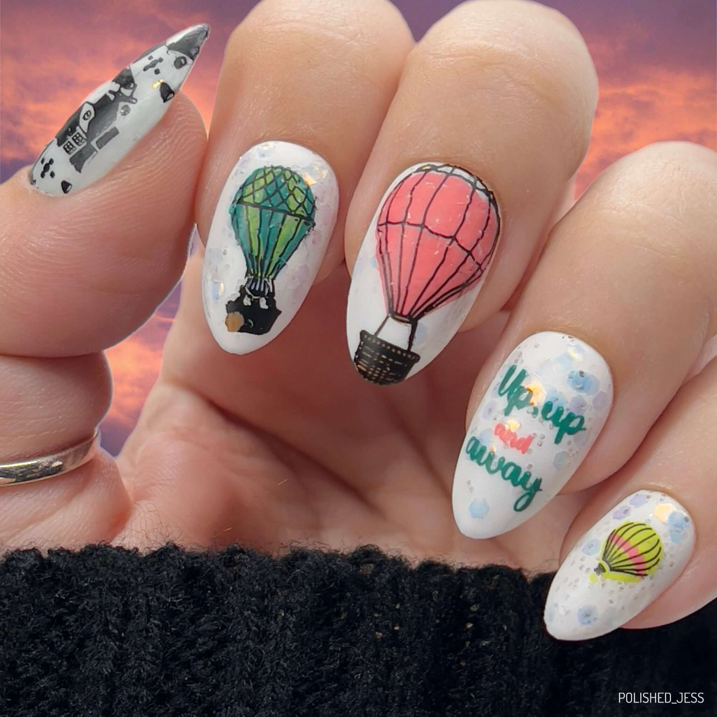 Bright-manicure-showing-nail-art-designs-of-hot-air-balloons-and-the-words-up-up-and-away