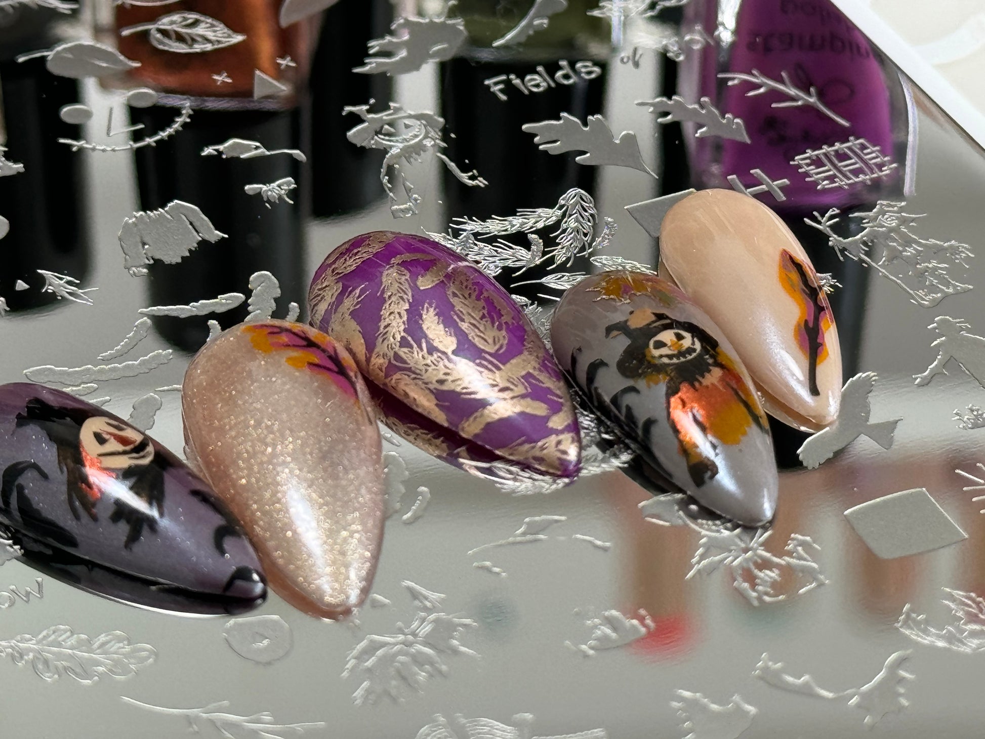 set-of-nail-tips-showing-nail-art-designs-of-a-scarecrow-and-wheat-stalks