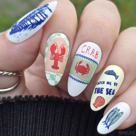 manicured-hand-showing-nail-layered-art-designs-of-crabs-lobsters-and-fish