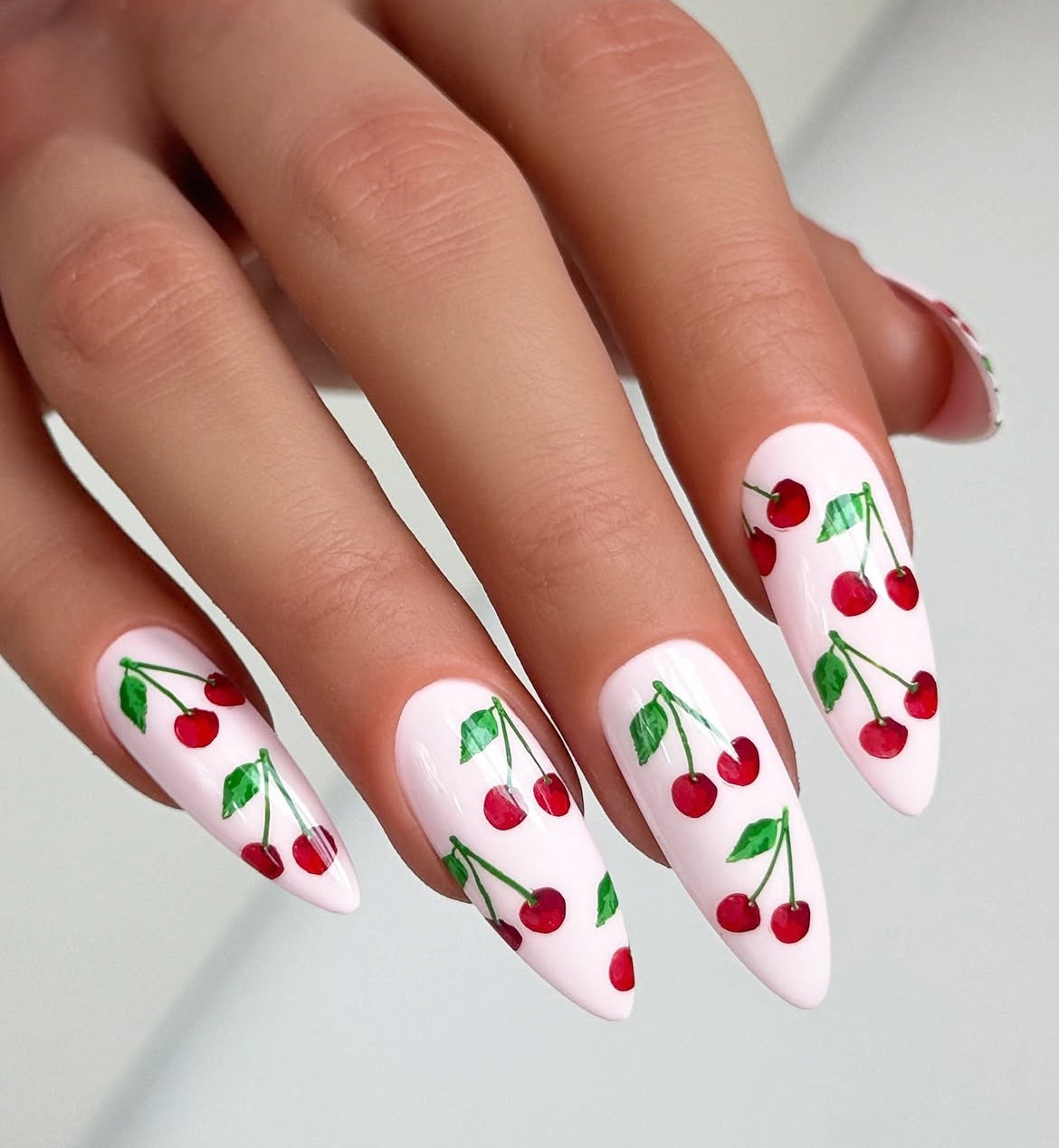stunning-manicured-hand-with-layered-nail-art-designs-of-pairs-of-cherries