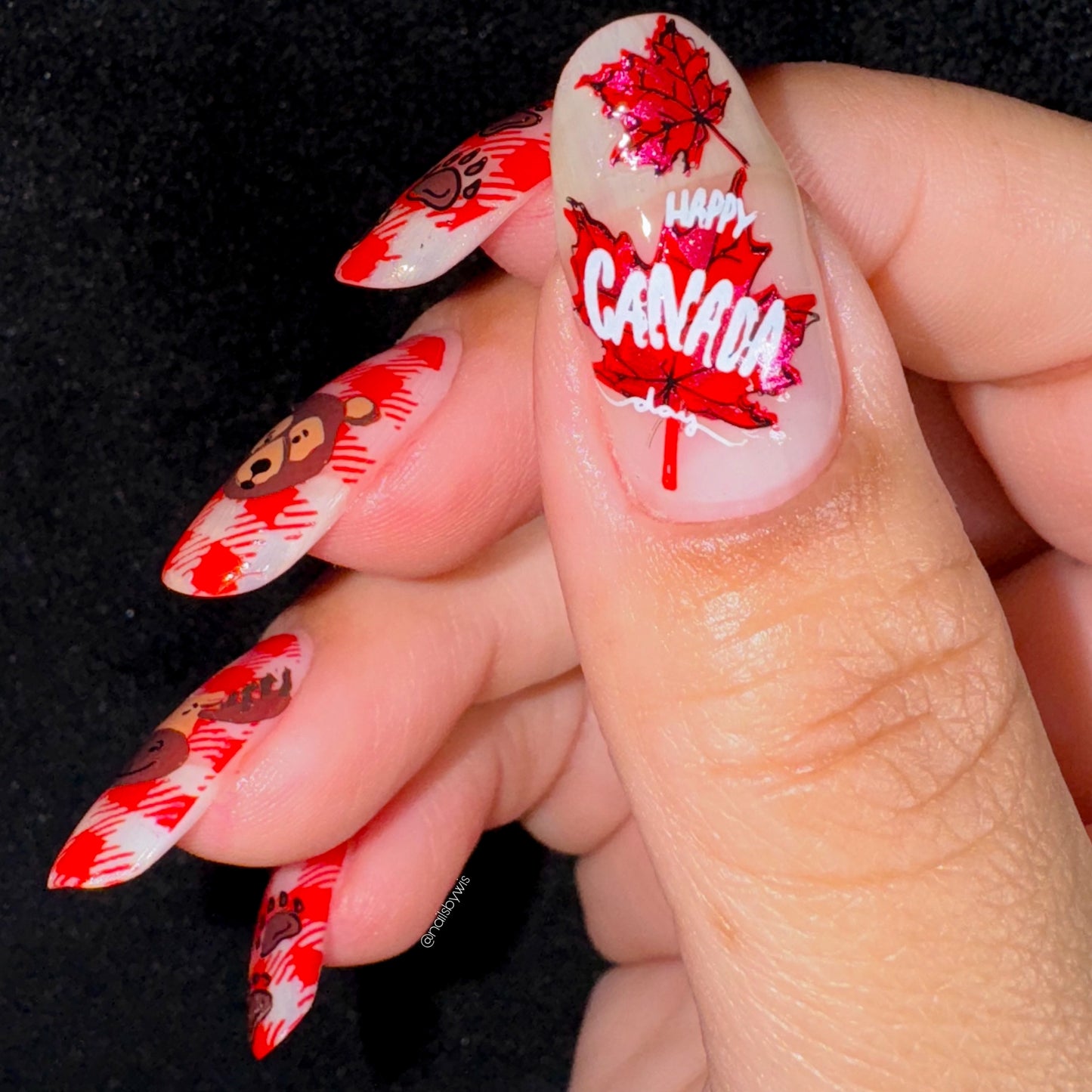 beautiful-manicured-thumb-nail-ahowing-nail-art-designs-of-two-maple-leaves-with-the-words-happy-canada-day