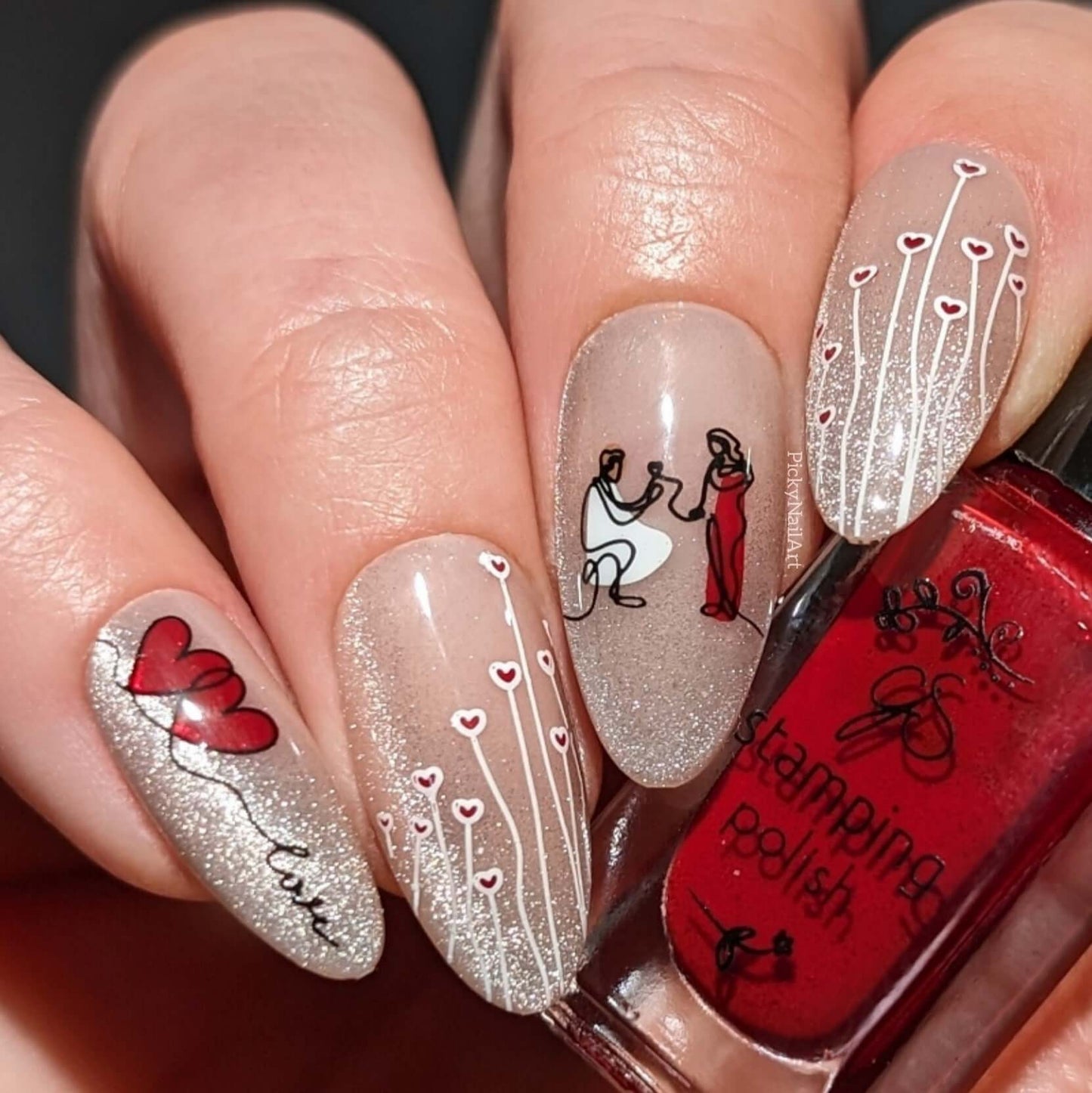 manicured-hand-with-stunning-nail-art-designs-of-a-marriage-proposal-and-words-love