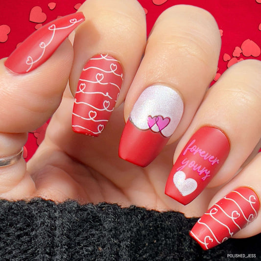manicured-hand-with-bright-valentines-nail-art-designs-of-swirly-hearts-and-words-forever-yours