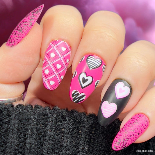 maniucred-hand-with-bright-nail-art-designs-of-hearts-with-patterns-on