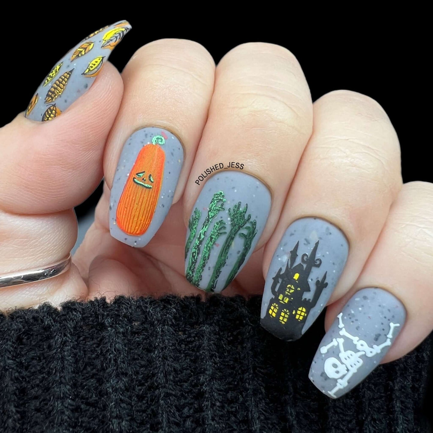 manicured-hand-with-layered-nail-art-designs-of-haunted-house-skeleton-and-pumpkin