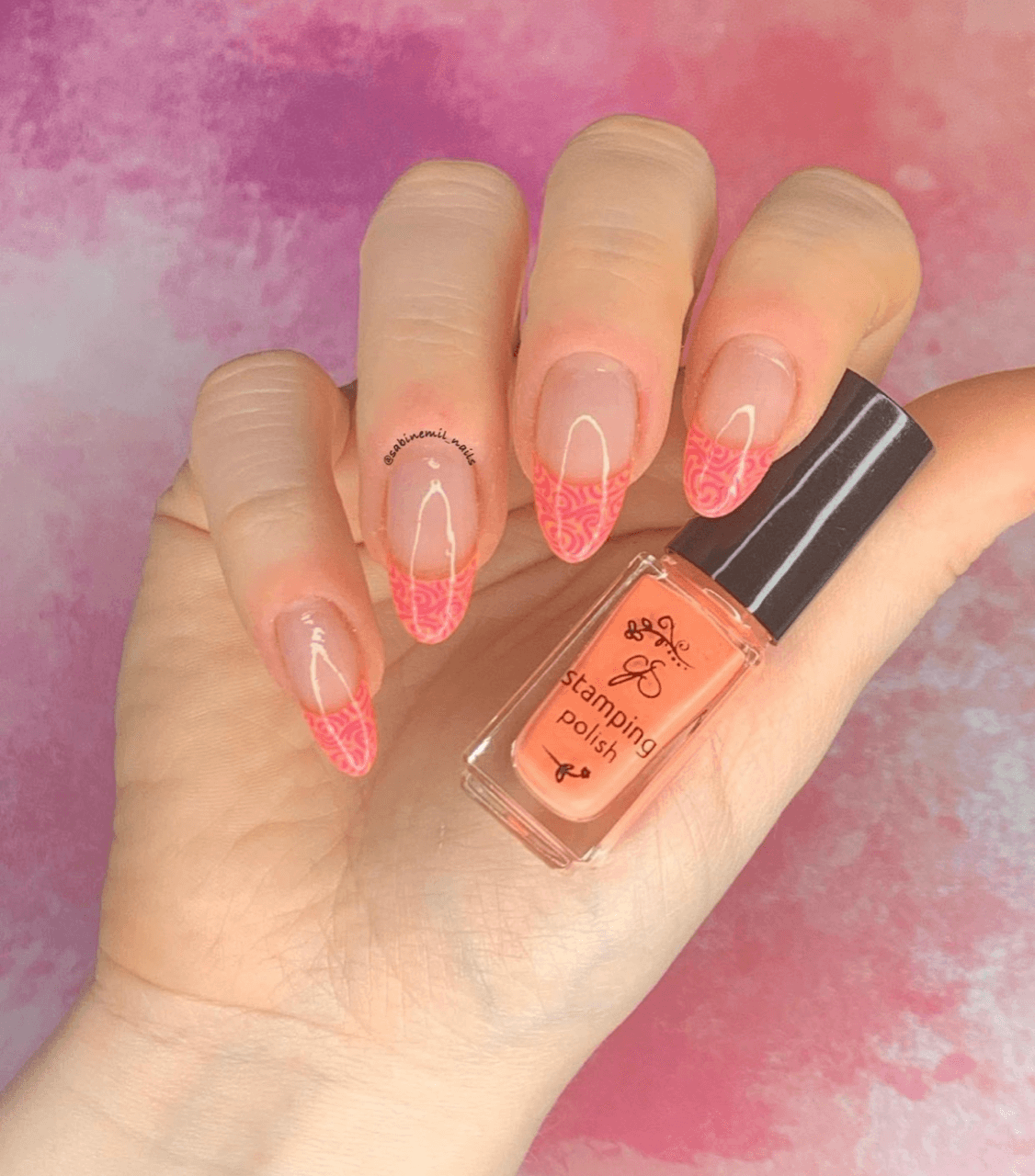 manicured-hand-holding-a-stamping-polish-bottle-with-nail-art-french-tip-designs