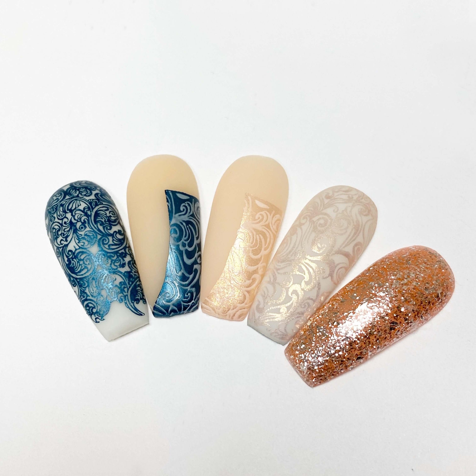 set-of-nail-tips-with-layered-nail-art-designs-of-baroque-patterns