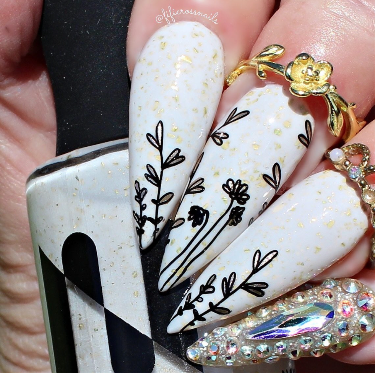 manciured-hand-with-layered-nail-art-designs-of-abstract-flowers-on-long-stalks