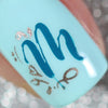 Single-manicured-nail-showing-the-letter-m-stamped-on-in-nail-art