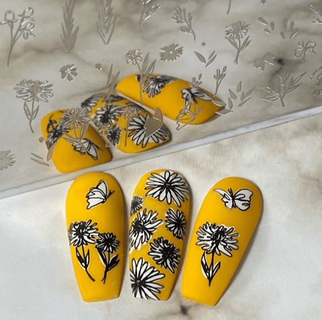 Set-of-three-manicured-nail-tips-with-stunning-nail-art-designs-of-flowers-and-butterflies