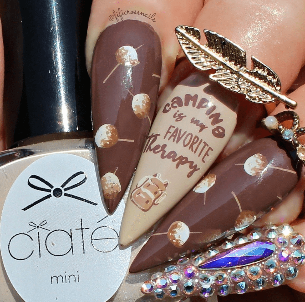 manicure-with-nail-art-designs-of-marshmallows-a-backpack-and-the-words-camping-is-my-favourite-therapy