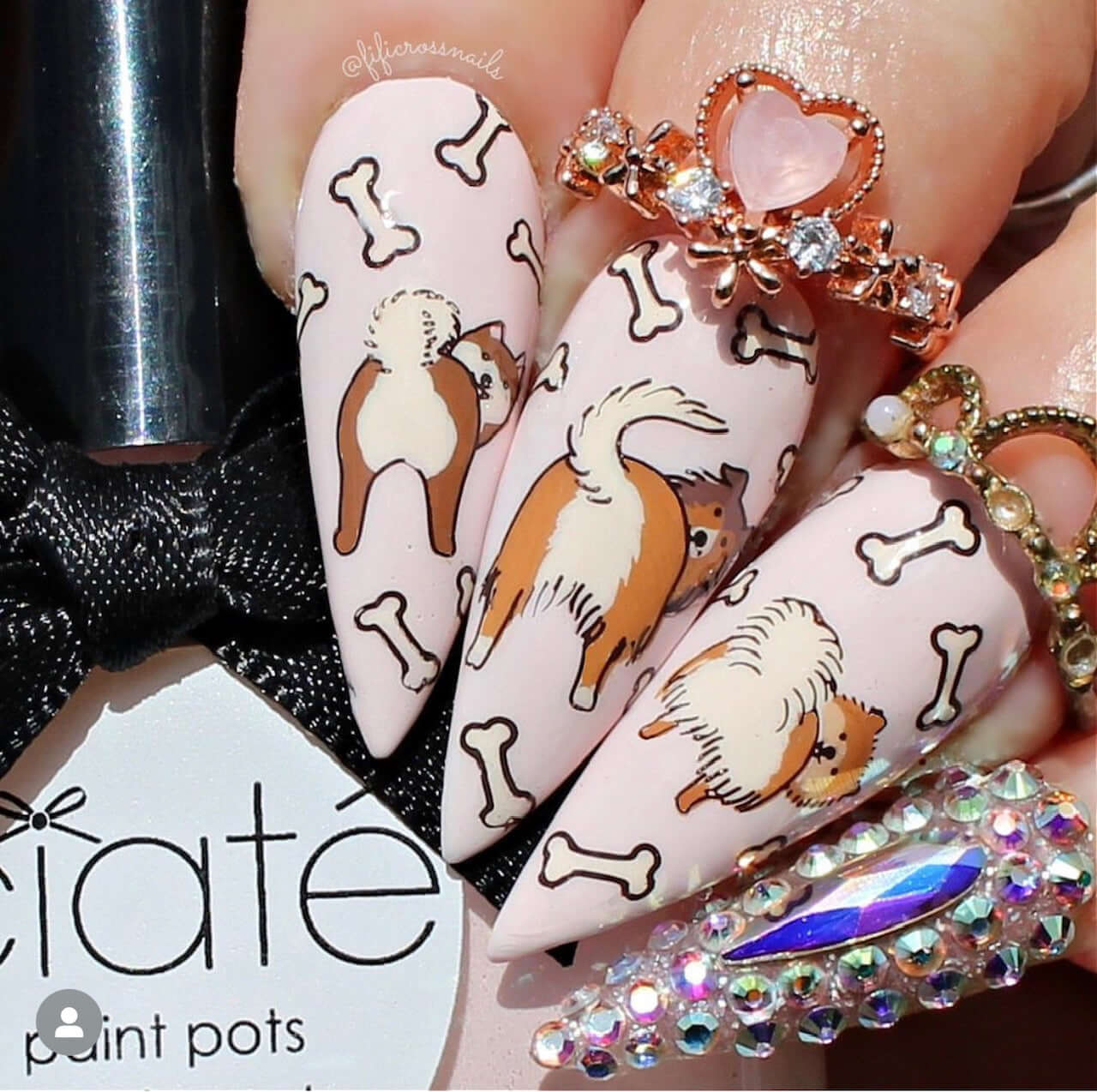 manicure-showing-layered-nail-art-designs-of-three-dogs-wagging-their-tails-and-bones