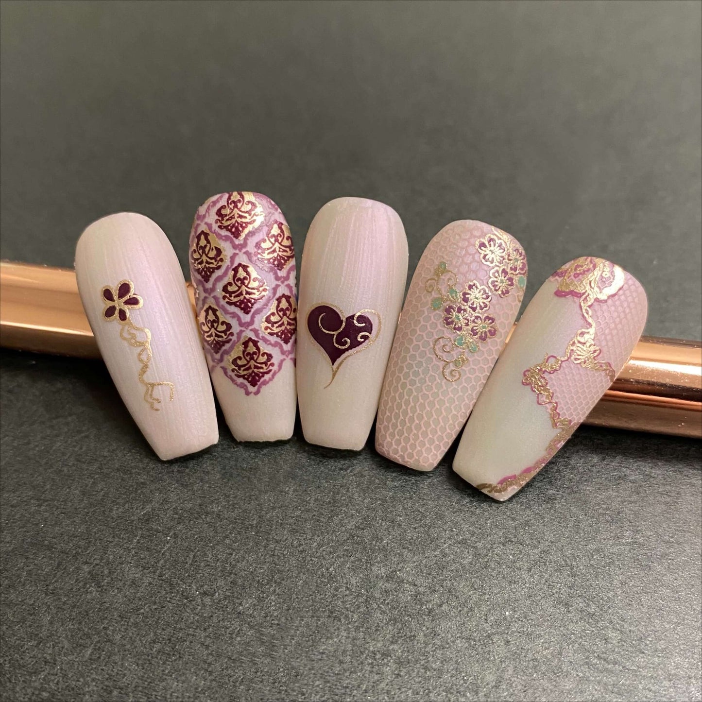 beautiful-manicured-nail-tips-showing-delicate-lace-and-swirl-nail-art-designs