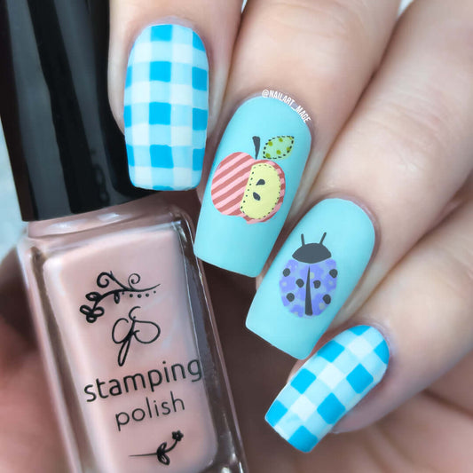 beautiful-manicure-showing-nail-art-designs-of-an-apple-and-ladybug-with-patchwork-designs