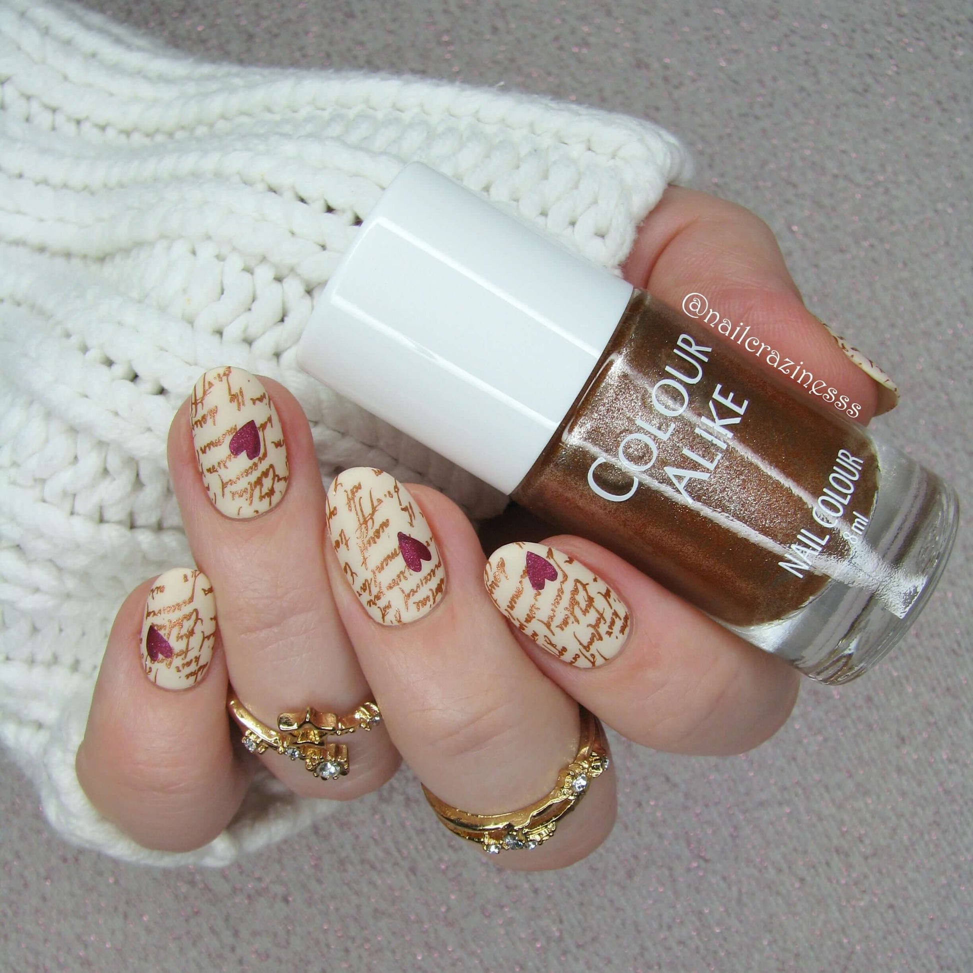 manicured-hand-with-nail-art-designs-of-script-and-hearts