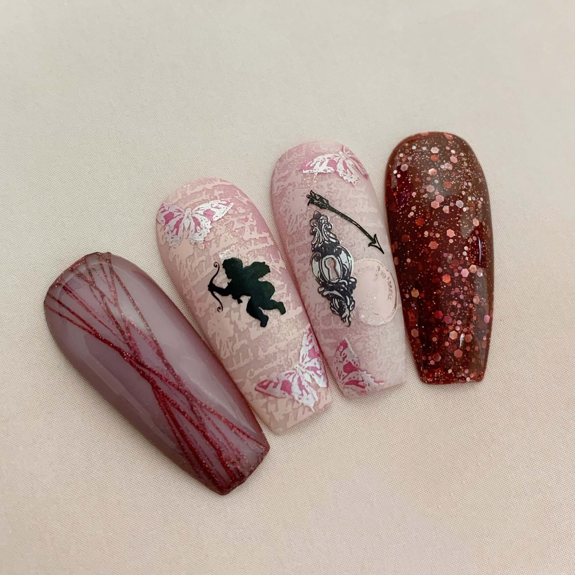 set-of-nail-tips-with-stunning-nail-art-designs-of-vintage-script-chrub-and-butterflies