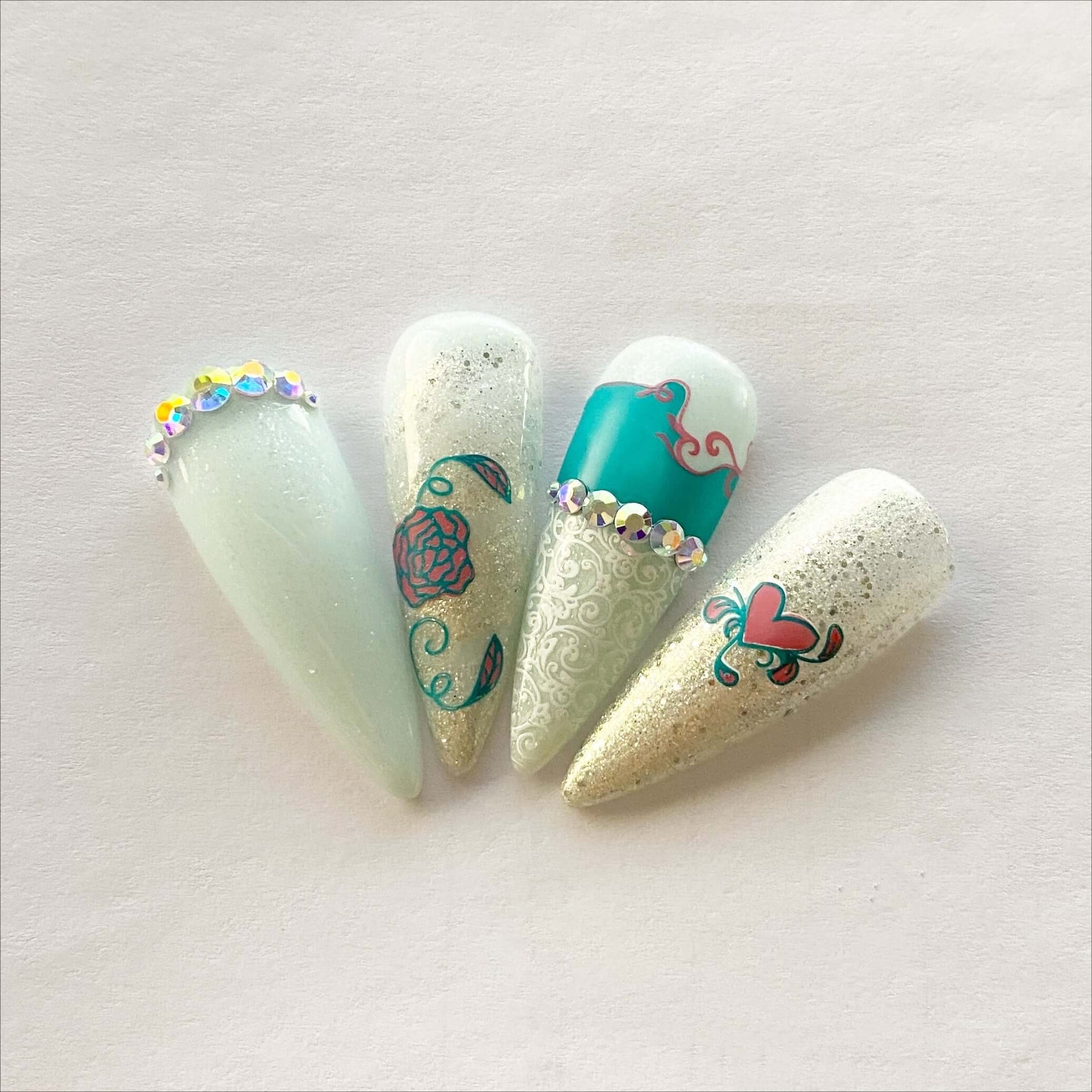 set-of-nail-tips-with-stunning-stamping-nail-art-designs of-swirls-and-hearts-with-crystal-embellishments.
