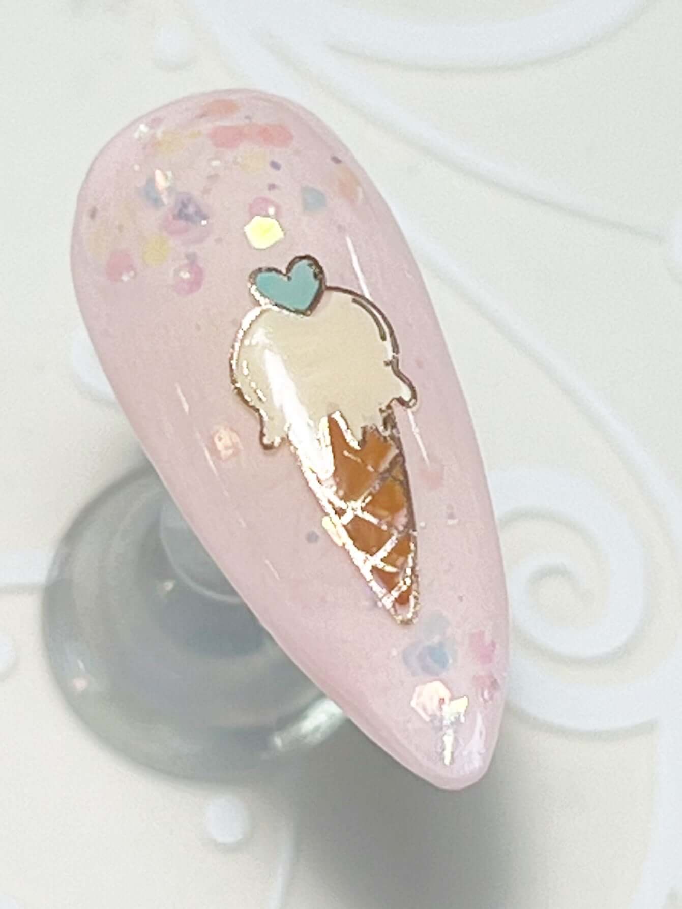 single-nail-tip-with-layered-nail-art-design-of-an-ice-cream-cone