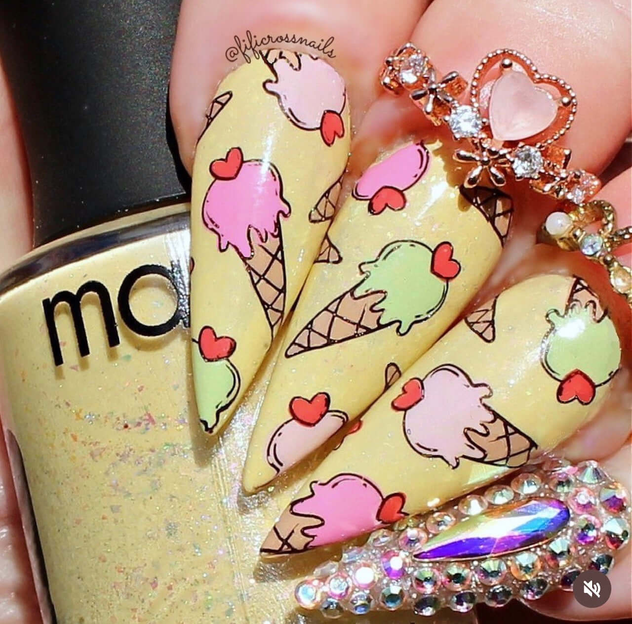 manicured-hand-with-bright-nail-art-designs-of-ice-cream-cones-with-hearts-on-top