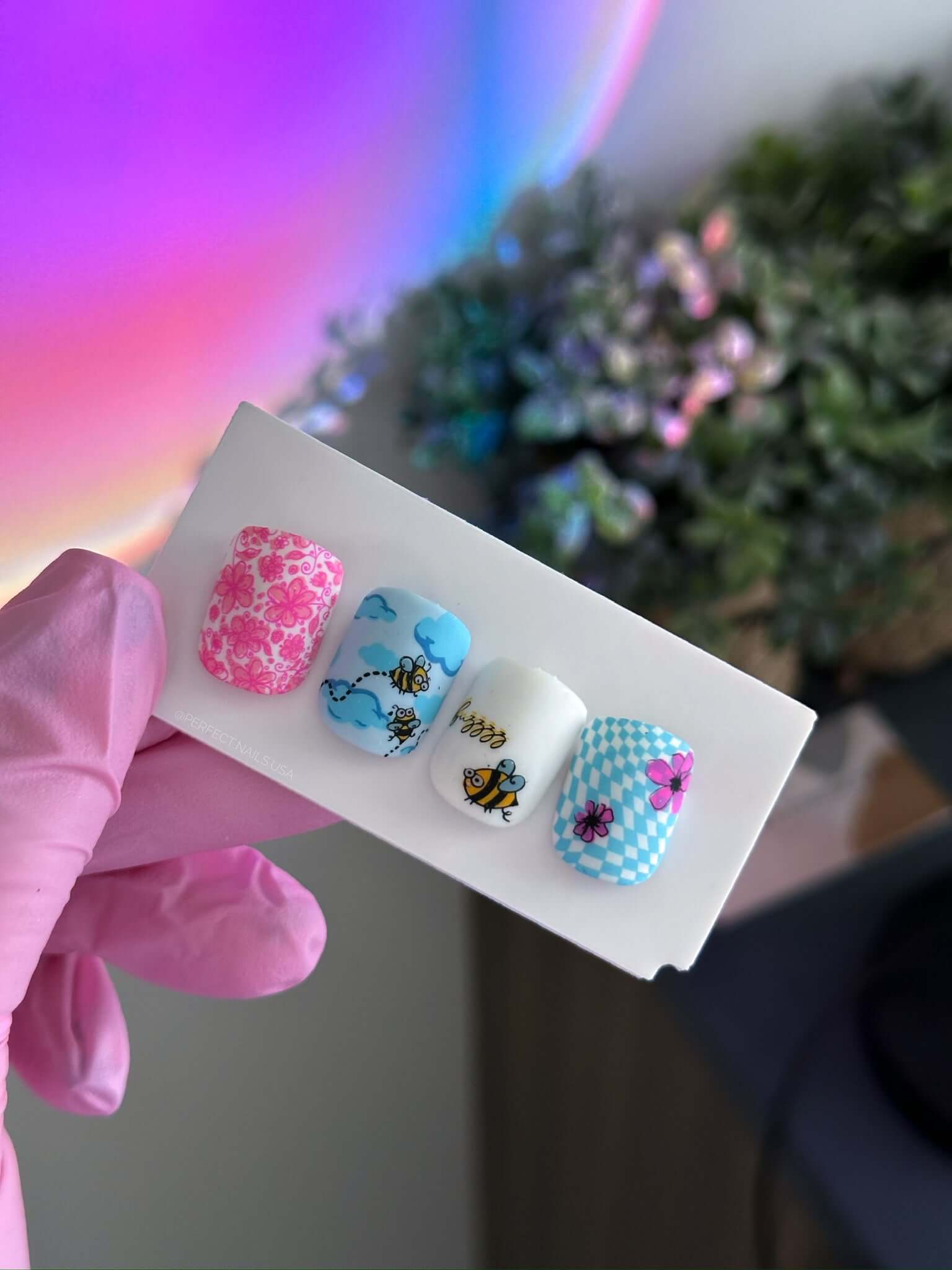 set-of-nail-tips-with-cute-nail-art-designs-of-bees-flowers-and-clouds