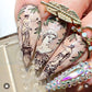 manciure-showing-nail-art-designs-of-greek-statues-and-olive-branches
