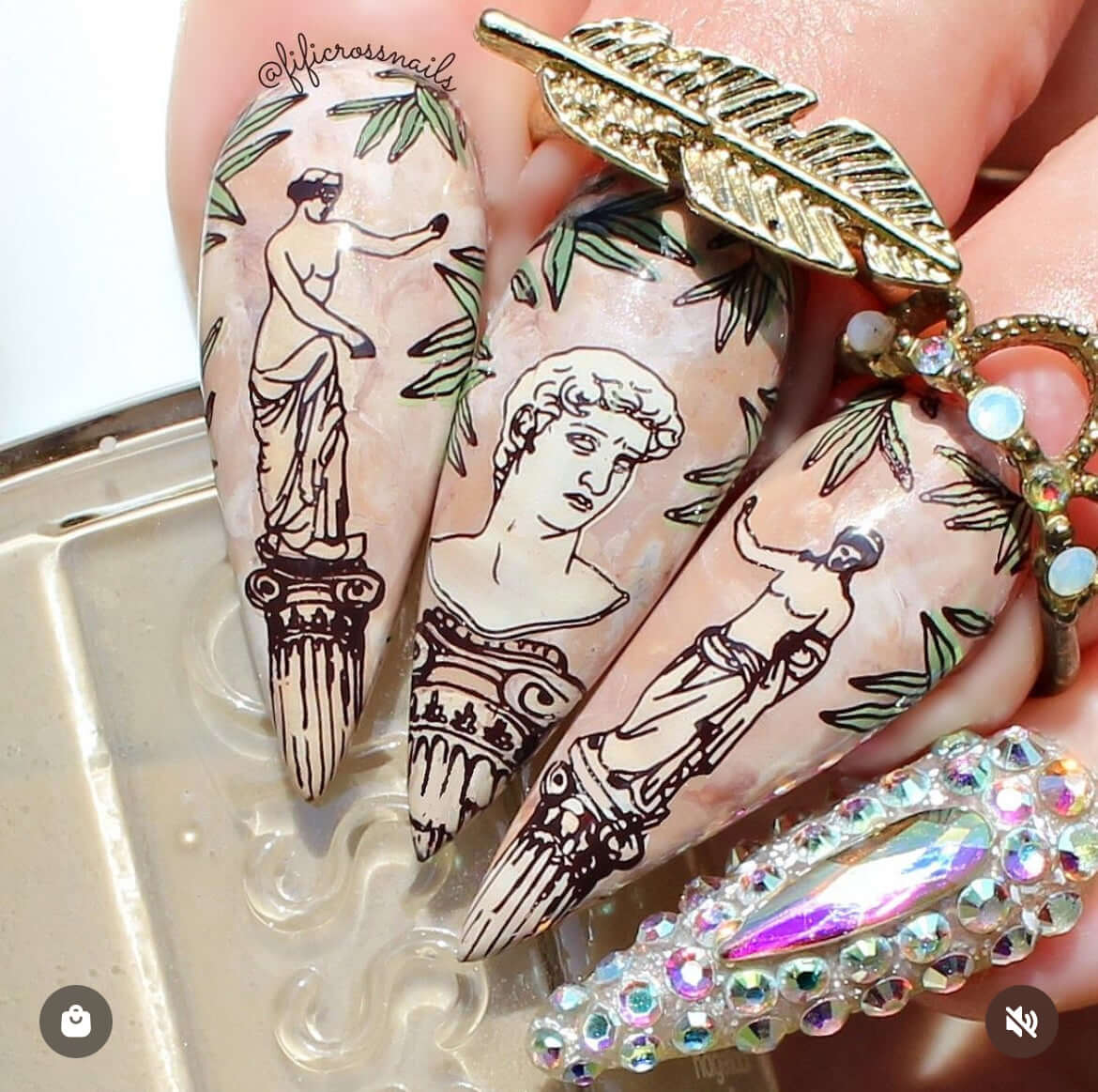 manciure-showing-nail-art-designs-of-greek-statues-and-olive-branches