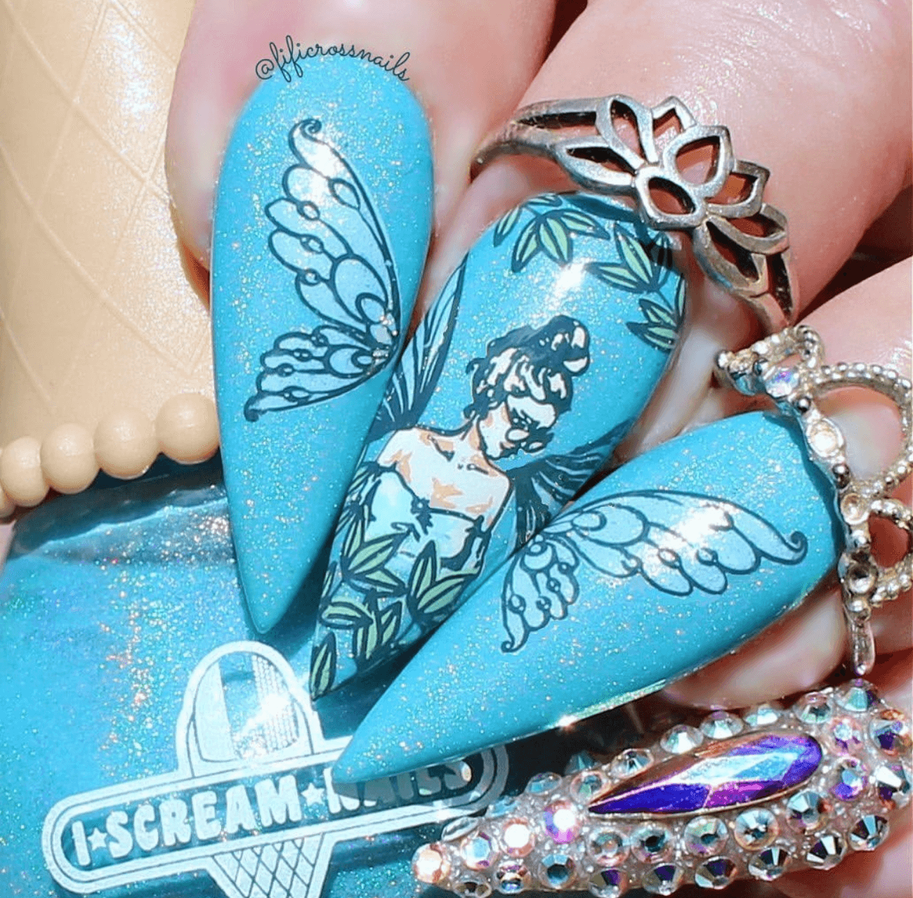 beautiful-blue-manicure-showing-nail-art-designs-of-a-fairy-with-wings