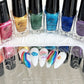Nail-tips-showing-beautfiul-shimmery-nail-art-designs-of-rainbows-and-stars-with-the-stamping-polishes-behind-them