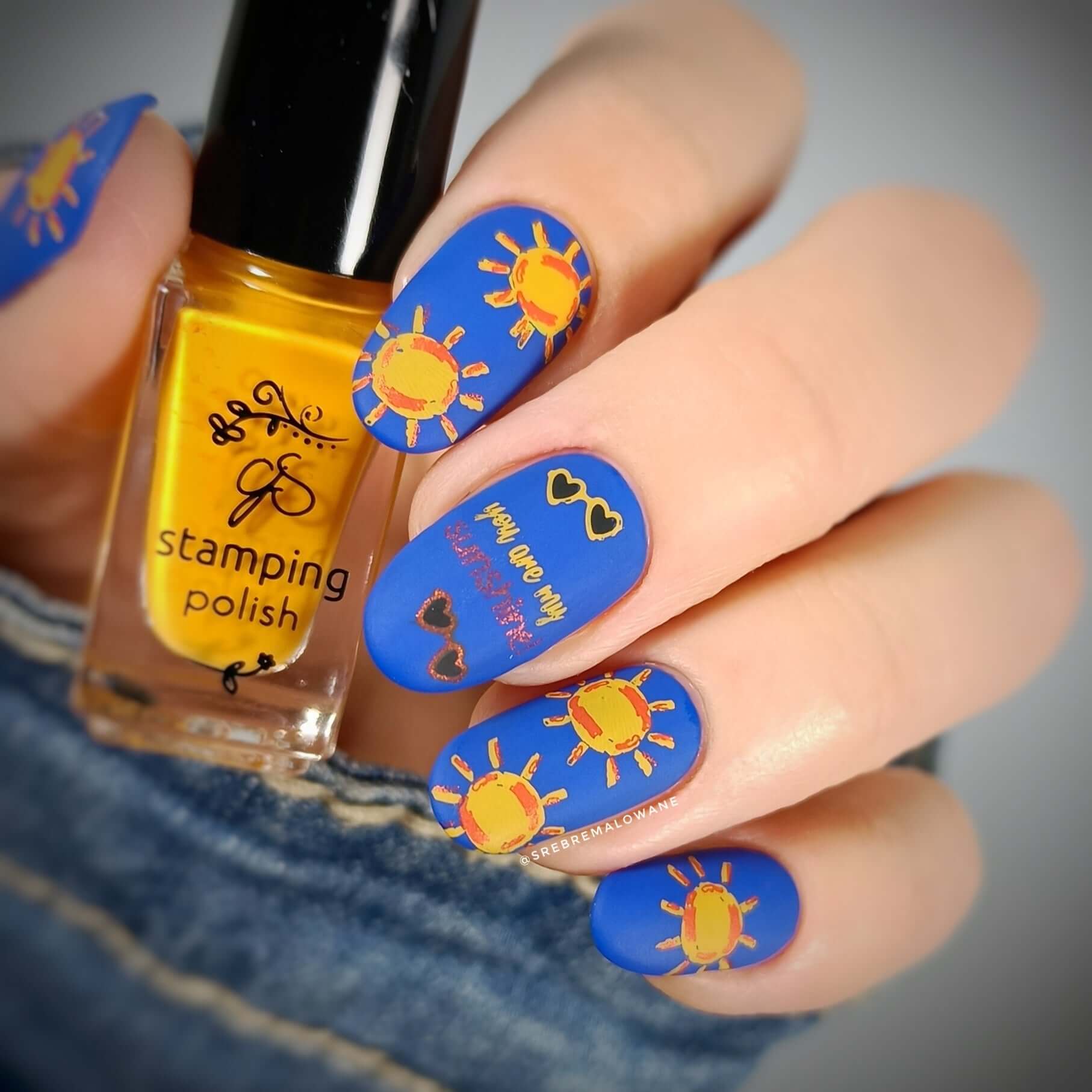 bright-blue-manicure-showing-nail-art-designs-of-suns-sunglasses-and-the-words-you-are-my-sunshine