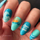 bright-blue-manicure-with-nail-art-designs-of-a-sun-and-waves-and-the-words-dance-with-the-waves