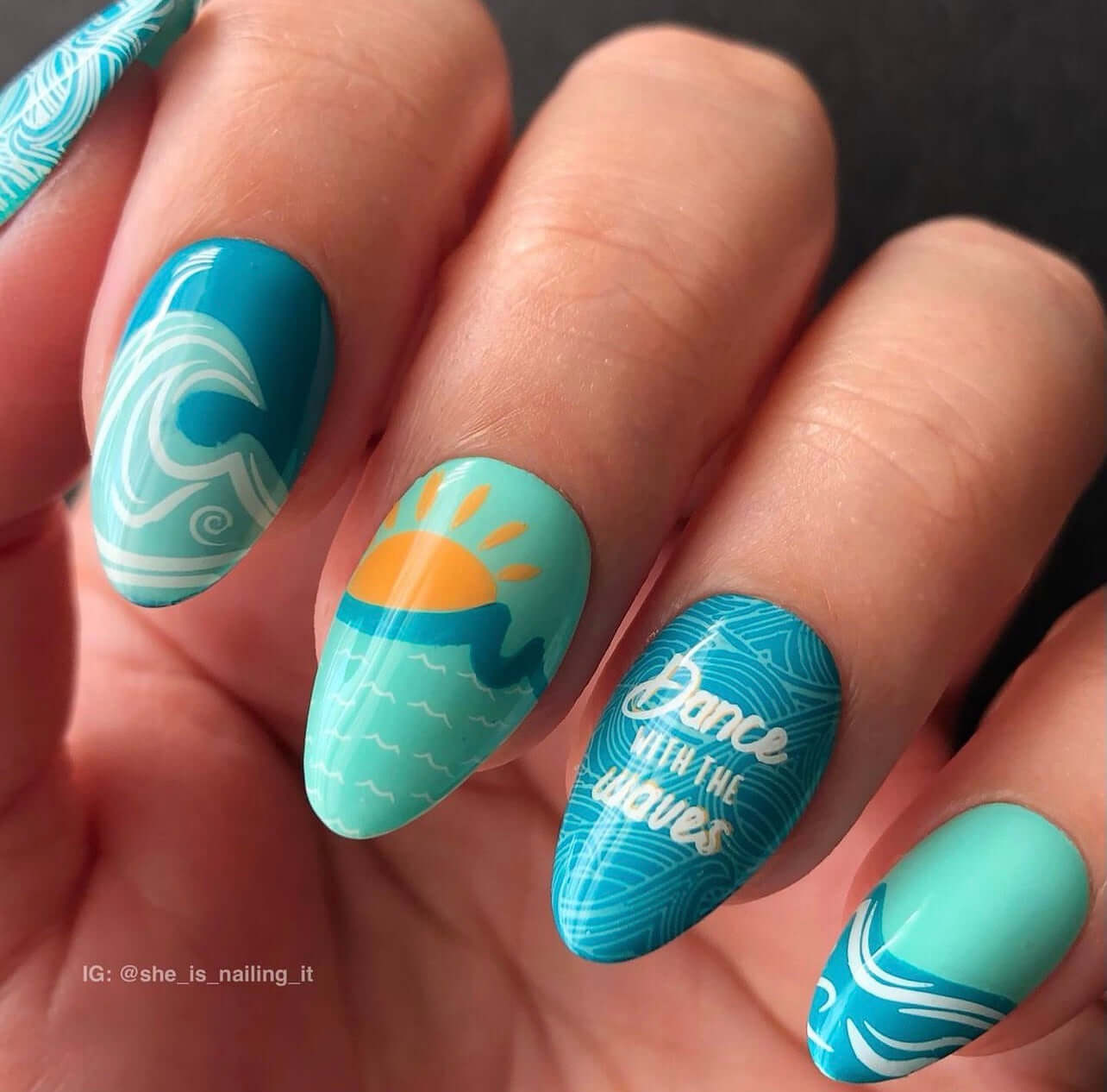 bright-blue-manicure-with-nail-art-designs-of-a-sun-and-waves-and-the-words-dance-with-the-waves