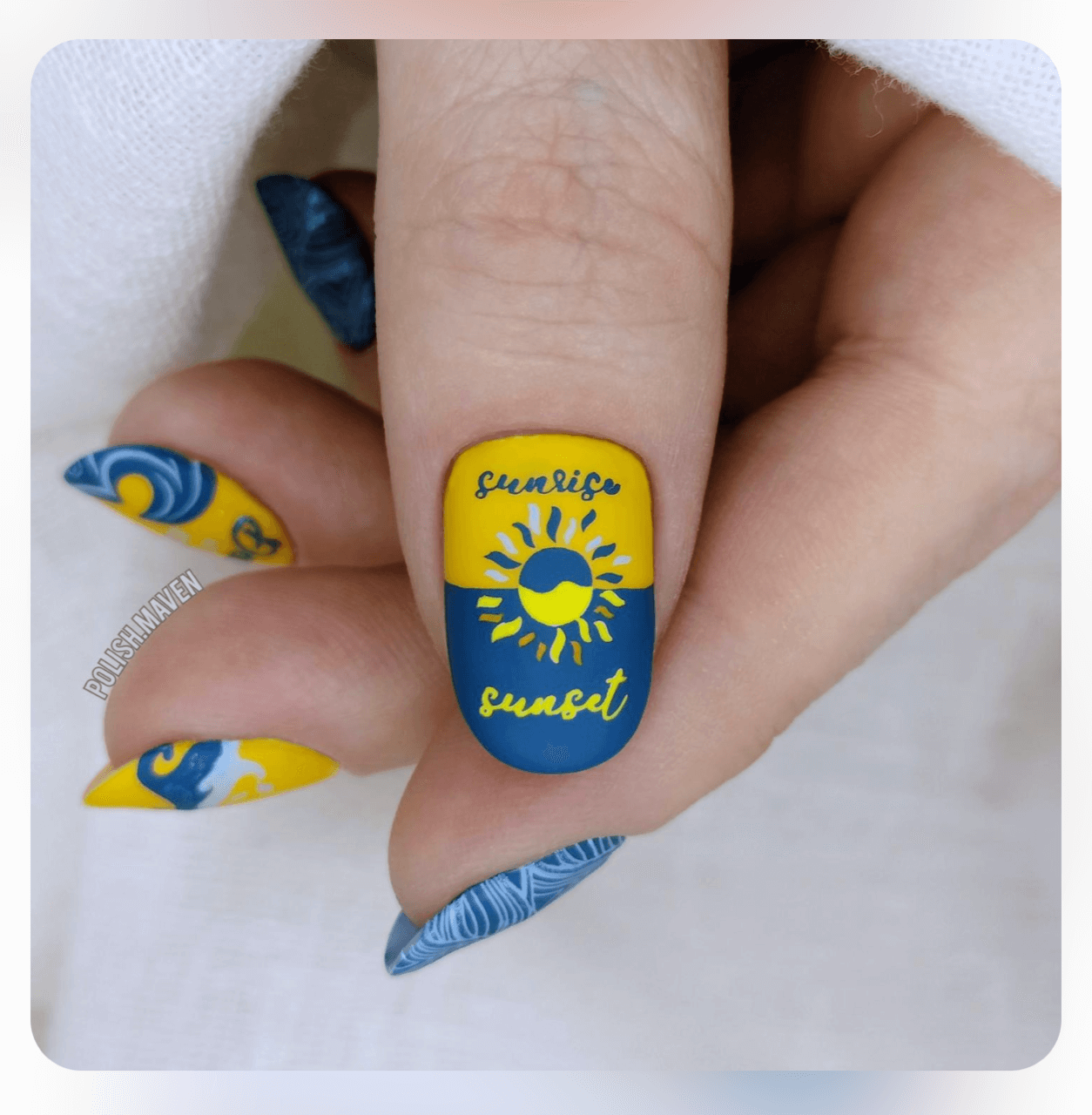 singled-manicured-nail-with-nail-art-design-of-a-sun-and-the-words-sunrise-and-sunset